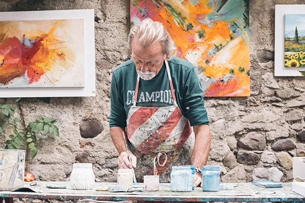 An image of an elderly person painting